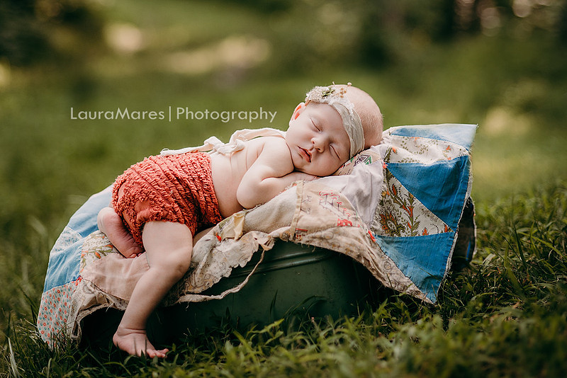 Outdoor sunset newborn portraits with quilt and antique tin dress in adorable romper  | Laura Mares Photography | Pittsburgh Newborn Photographer